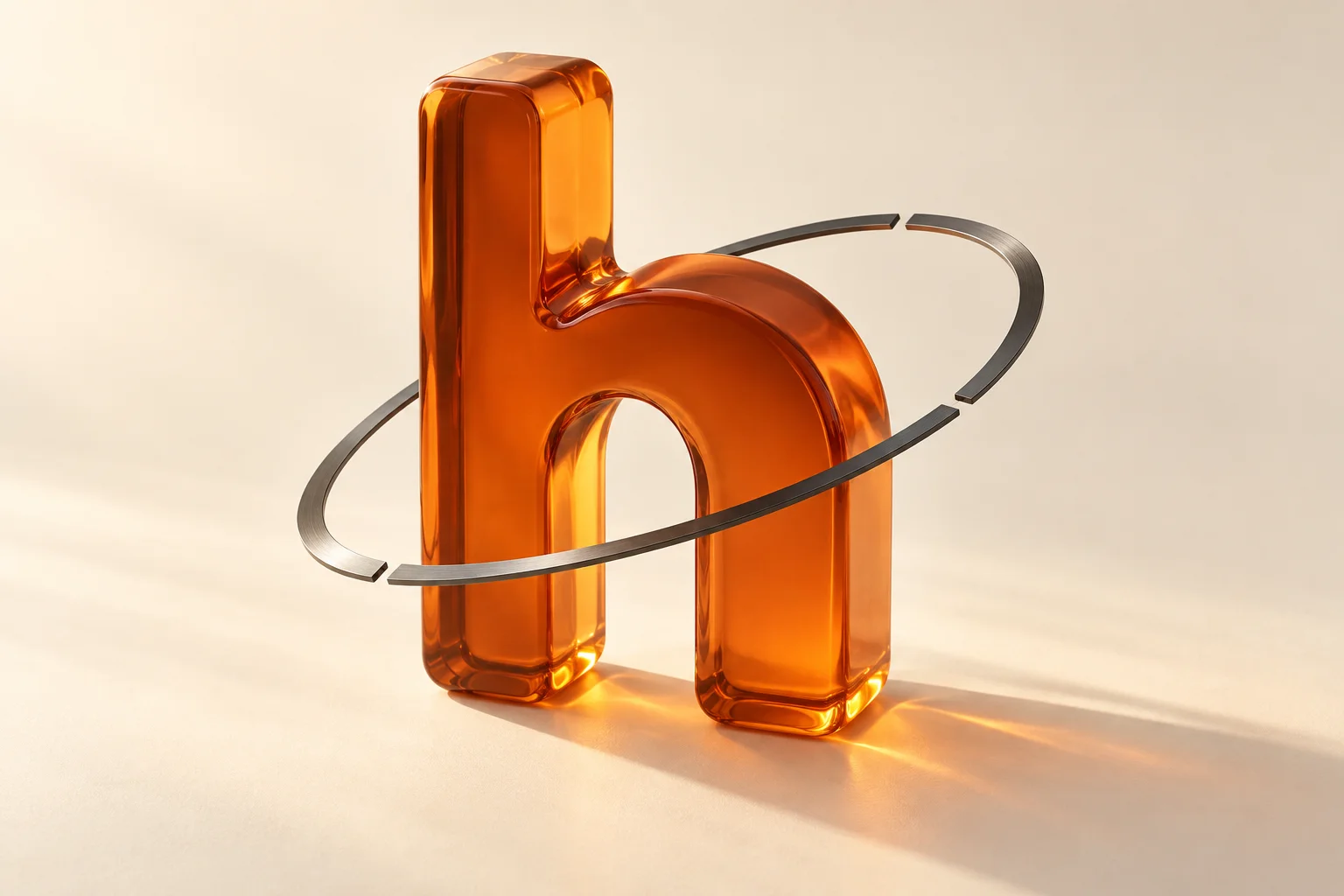 Translucent orange h surrounded by a thin segmented graphite orbit in warm light